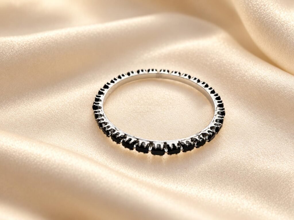 Silver toned black stone bangle. Size (2 x 6)